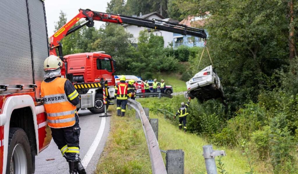 Mașină ridicată din albia unui pârâu, în Austria. Mai mulți pompieri supraveghează acțiunea
